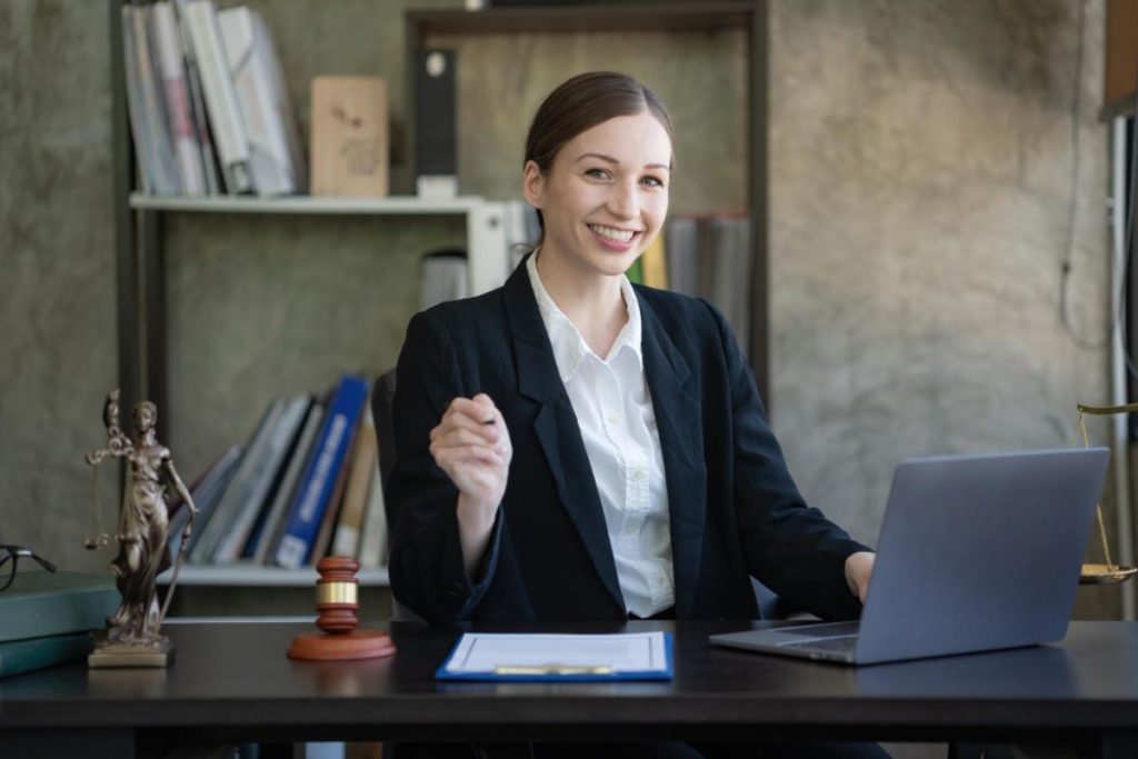 Advogada sorridente sentada em um escritório, representando uma Sociedade Unipessoal de Advocacia.